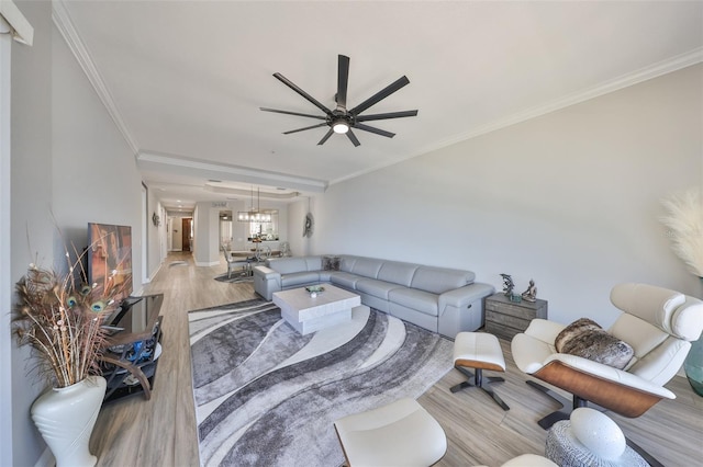 1038 Bellasol Way Unit 202, Apollo Beach, FL 33572 - living room with light wood-type flooring, ceiling fan, ornamental molding, and a chandelier