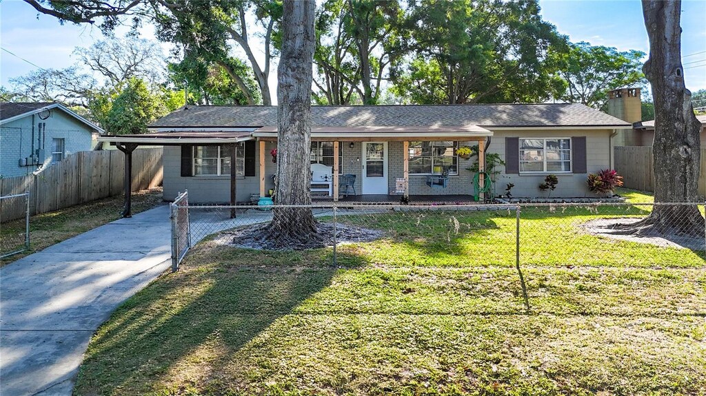 9616 Oak Ridge Ave, Riverview, FL 33578 - ranch-style house with a chimney, driveway, fence, and a front lawn