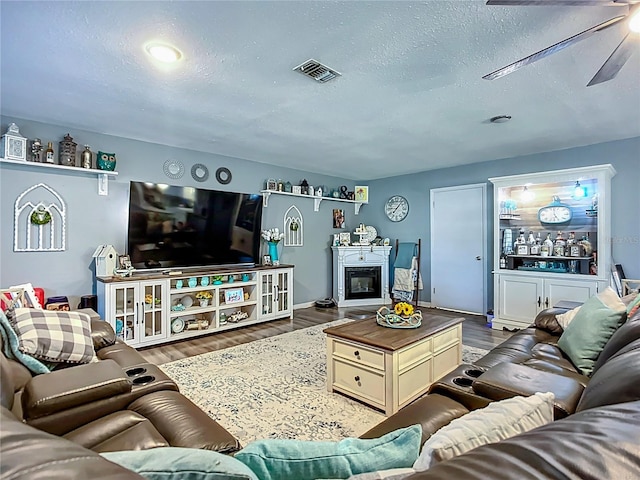 9616 Oak Ridge Ave, Riverview, FL 33578 - living room featuring a ceiling fan, wood finished floors, a textured ceiling, and visible vents