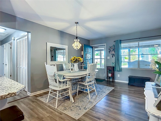 9616 Oak Ridge Ave, Riverview, FL 33578 - dining area with baseboards, wood finished floors, and a chandelier