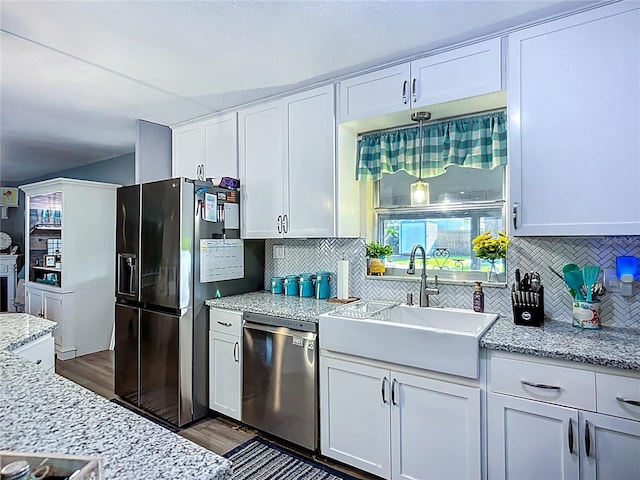9616 Oak Ridge Ave, Riverview, FL 33578 - kitchen featuring white cabinetry, tasteful backsplash, stainless steel appliances, dark wood finished floors, and a sink