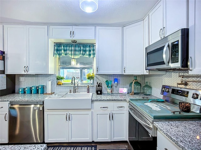9616 Oak Ridge Ave, Riverview, FL 33578 - kitchen featuring white cabinets, decorative backsplash, a sink, and stainless steel appliances