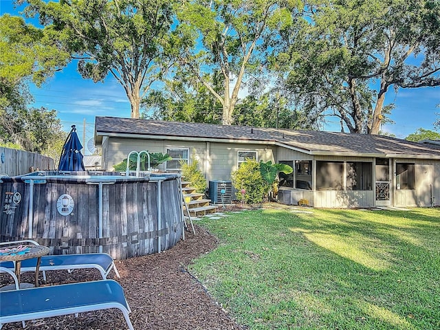 9616 Oak Ridge Ave, Riverview, FL 33578 - back of house with a sunroom, fence, a yard, and an outdoor pool