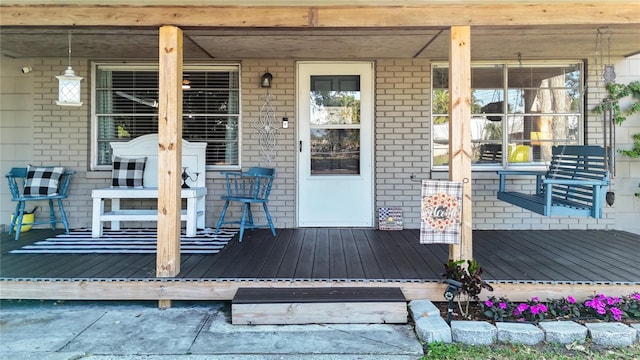 9616 Oak Ridge Ave, Riverview, FL 33578 - doorway to property featuring brick siding and covered porch