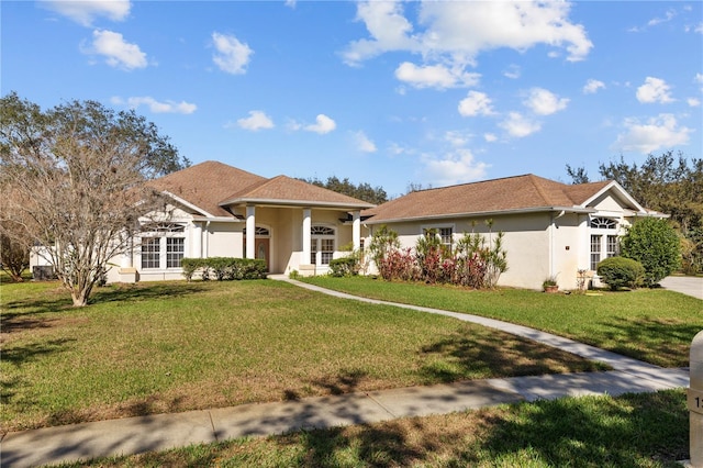13750 Dowling Ln, Odessa, FL 33556 - single story home featuring french doors, a front yard, and stucco siding