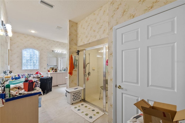 13750 Dowling Ln, Odessa, FL 33556 - full bathroom with wallpapered walls, a stall shower, and vanity