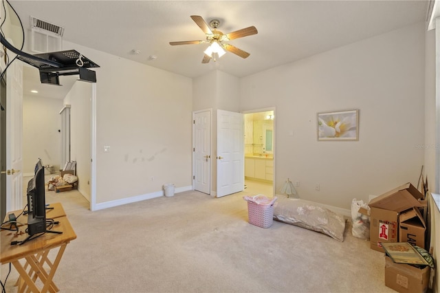 13750 Dowling Ln, Odessa, FL 33556 - bedroom with light carpet, baseboards, ensuite bathroom, and a ceiling fan