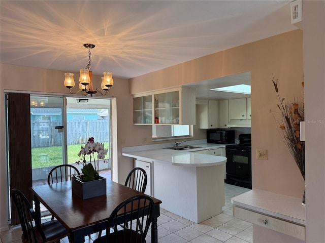 14264 Page Ave, Largo, FL 33774 - dining space featuring light tile patterned floors and a chandelier