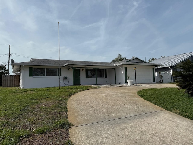 14264 Page Ave, Largo, FL 33774 - single story home with stucco siding, fence, driveway, a front lawn, and a garage