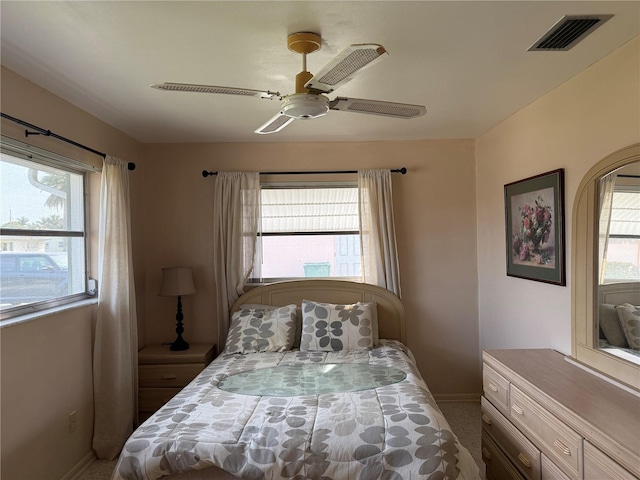 14264 Page Ave, Largo, FL 33774 - bedroom with baseboards, visible vents, carpet flooring, and a ceiling fan