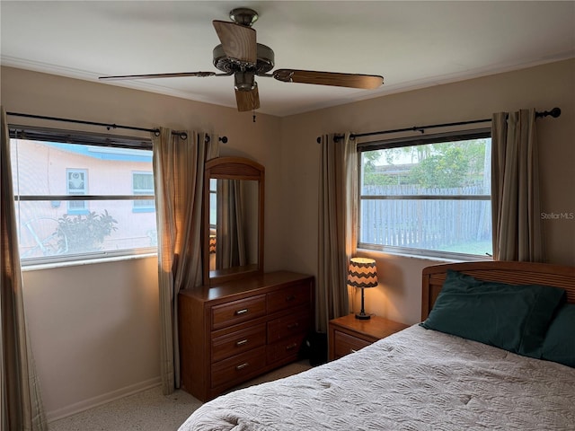 14264 Page Ave, Largo, FL 33774 - bedroom with baseboards, light speckled floor, and a ceiling fan