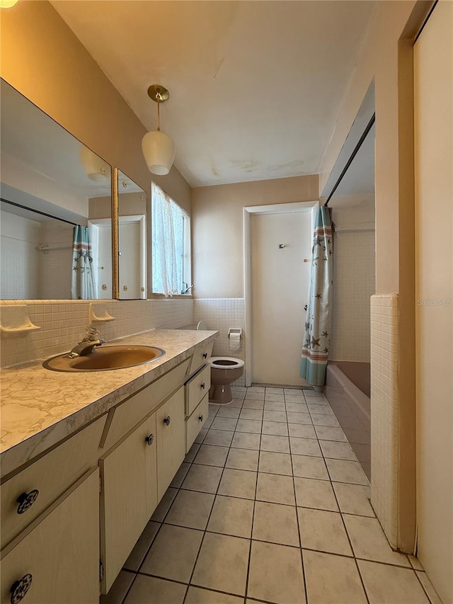 14264 Page Ave, Largo, FL 33774 - full bathroom with tile patterned floors, tile walls, toilet, vanity, and shower / bath combination with curtain