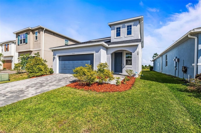 7334 Ashcroft Dr, Wesley Chapel, FL 33545 - view of front facade featuring stucco siding, an attached garage, a front yard, and decorative driveway