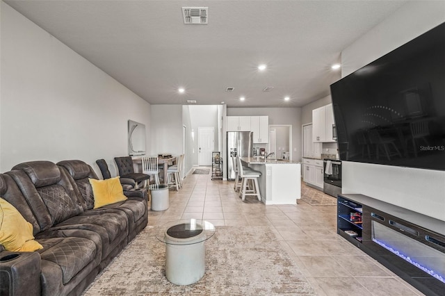 7334 Ashcroft Dr, Wesley Chapel, FL 33545 - living room with light tile patterned floors, recessed lighting, and visible vents