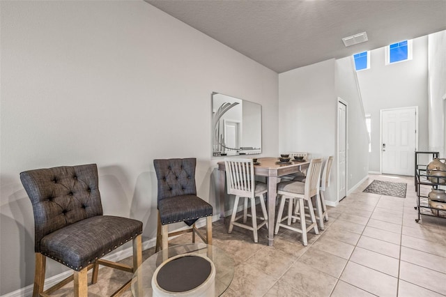 7334 Ashcroft Dr, Wesley Chapel, FL 33545 - dining area featuring light tile patterned flooring, baseboards, a textured ceiling, and visible vents