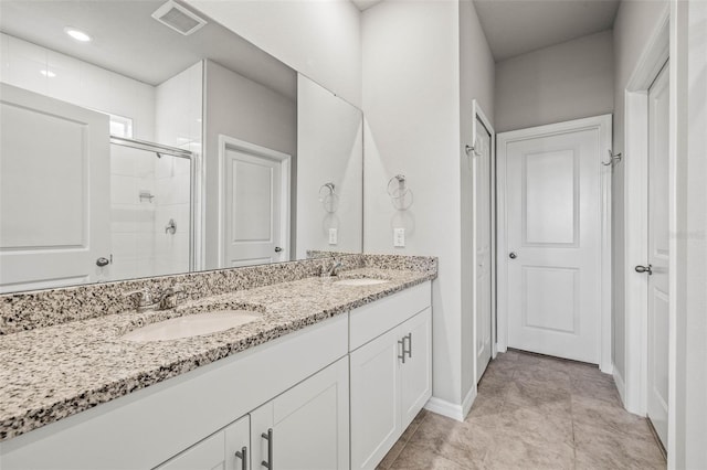 7334 Ashcroft Dr, Wesley Chapel, FL 33545 - full bath featuring a stall shower, double vanity, visible vents, and a sink