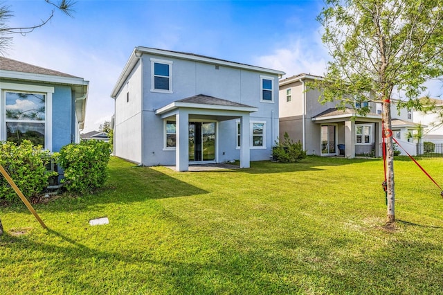 7334 Ashcroft Dr, Wesley Chapel, FL 33545 - rear view of property with a lawn, fence, and stucco siding