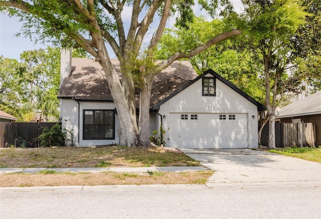 7227 Otter Creek Dr, New Port Richey, FL 34655 - view of front facade featuring driveway, a chimney, fence, an attached garage, and brick siding