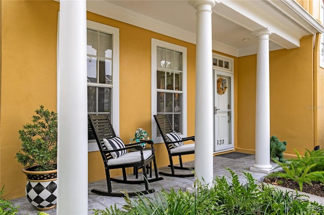 property entrance featuring a porch and stucco siding
