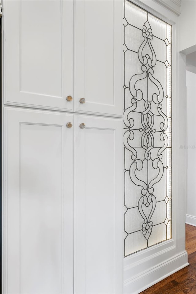 interior details featuring baseboards and wood finished floors
