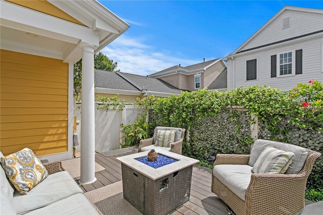 view of patio / terrace with an outdoor living space with a fire pit, fence, and a wooden deck