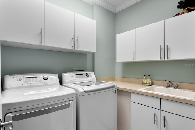 laundry area with washer and dryer, a sink, ornamental molding, and cabinet space