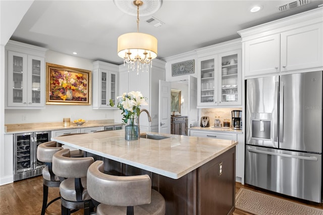 kitchen featuring visible vents, white cabinets, stainless steel fridge, wine cooler, and dark wood-style floors