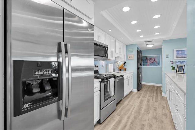 200 120th Ave W Unit 3A, Treasure Island, FL 33706 - kitchen featuring stainless steel appliances, a raised ceiling, white cabinets, recessed lighting, and light countertops