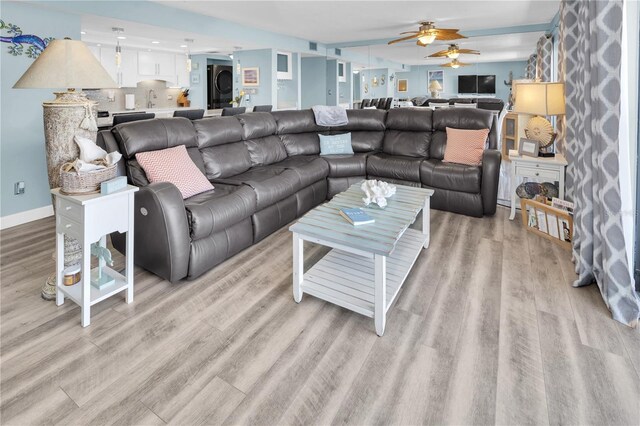 200 120th Ave W Unit 3A, Treasure Island, FL 33706 - living room with light wood-type flooring, a ceiling fan, estacked washer and dryer, baseboards, and recessed lighting