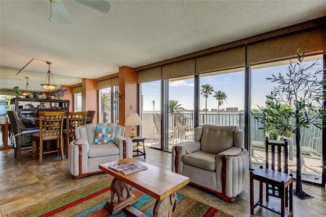 80 Rogers St Unit 2A, Clearwater, FL 33756 - living room featuring a textured ceiling and a ceiling fan