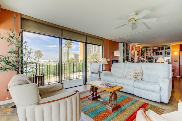 80 Rogers St Unit 2A, Clearwater, FL 33756 - living room featuring ceiling fan and a wall of windows