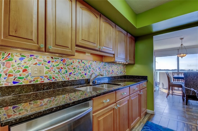 80 Rogers St Unit 2A, Clearwater, FL 33756 - kitchen with dark stone countertops, decorative backsplash, hanging light fixtures, a sink, and dishwasher