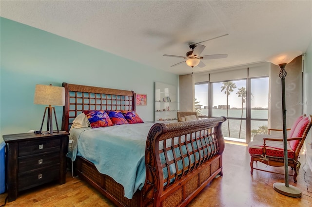 80 Rogers St Unit 2A, Clearwater, FL 33756 - bedroom with a textured ceiling, ceiling fan, and access to outside