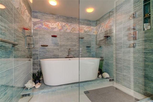 80 Rogers St Unit 2A, Clearwater, FL 33756 - full bath featuring a freestanding bath, tiled shower, and tile walls