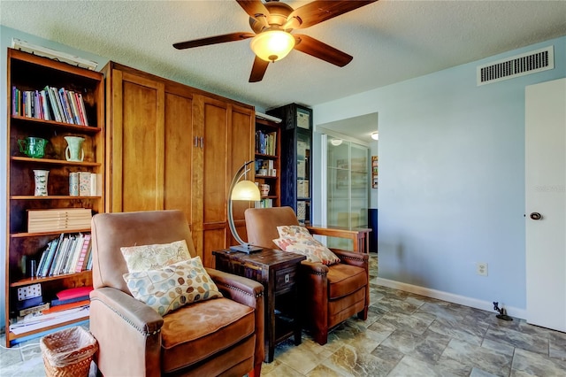 80 Rogers St Unit 2A, Clearwater, FL 33756 - sitting room featuring a textured ceiling, baseboards, ceiling fan, and visible vents