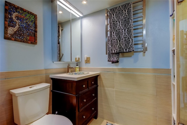 80 Rogers St Unit 2A, Clearwater, FL 33756 - bathroom with vanity, tile walls, recessed lighting, toilet, and a wainscoted wall