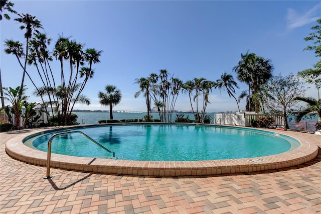 80 Rogers St Unit 2A, Clearwater, FL 33756 - pool featuring a water view, fence, and a patio