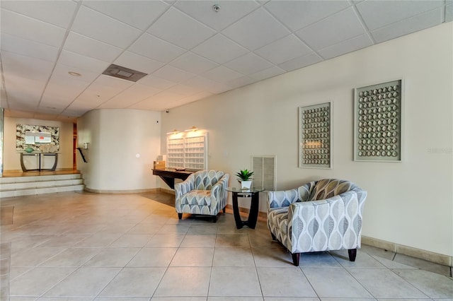 80 Rogers St Unit 2A, Clearwater, FL 33756 - living area with light tile patterned floors, visible vents, baseboards, and a paneled ceiling