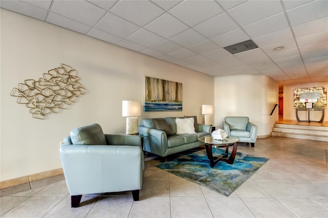 80 Rogers St Unit 2A, Clearwater, FL 33756 - living room featuring baseboards, stairs, a paneled ceiling, and light tile patterned floors