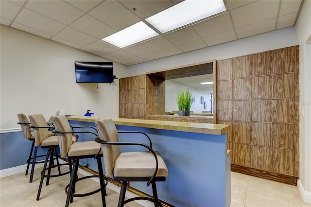 80 Rogers St Unit 2A, Clearwater, FL 33756 - bar with light tile patterned flooring, baseboards, and a drop ceiling