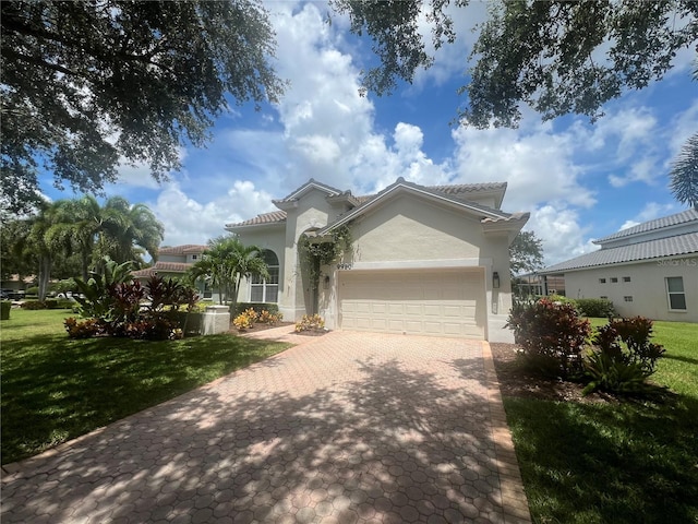 view of front of property with a front yard, decorative driveway, a garage, and stucco siding