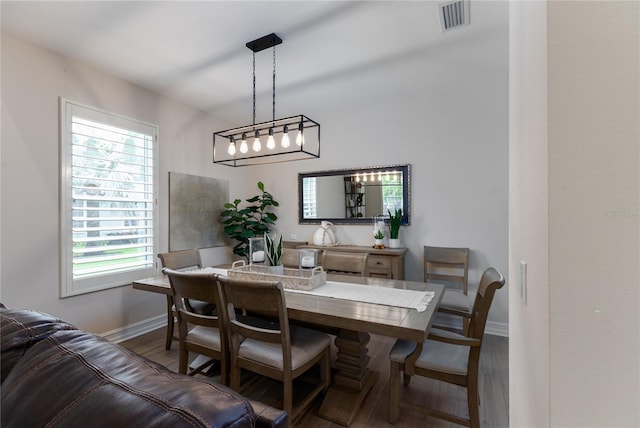 dining space featuring visible vents, baseboards, and wood finished floors