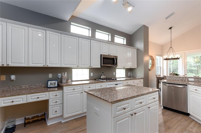 kitchen featuring white cabinets, appliances with stainless steel finishes, light wood finished floors, and visible vents