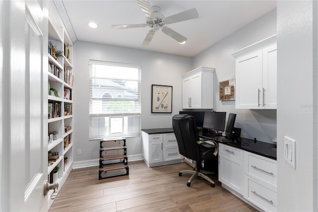 office with baseboards, built in desk, light wood-style floors, ceiling fan, and recessed lighting