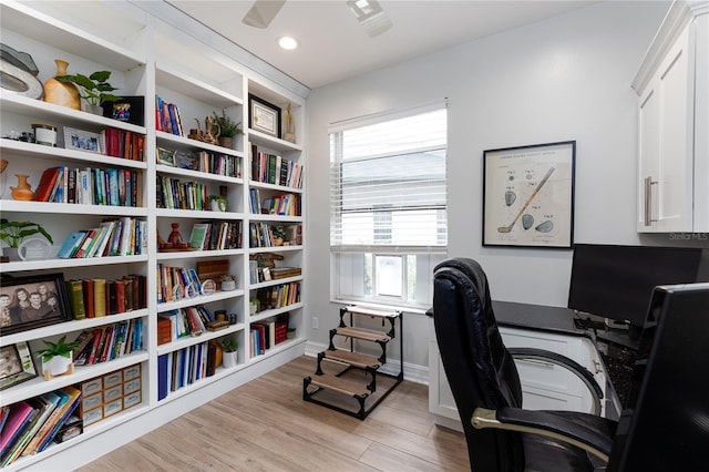 office area with baseboards and light wood-style flooring