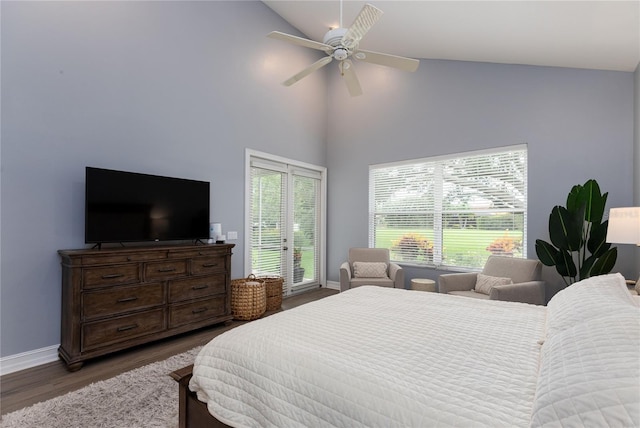 bedroom featuring baseboards, access to exterior, wood finished floors, and vaulted ceiling