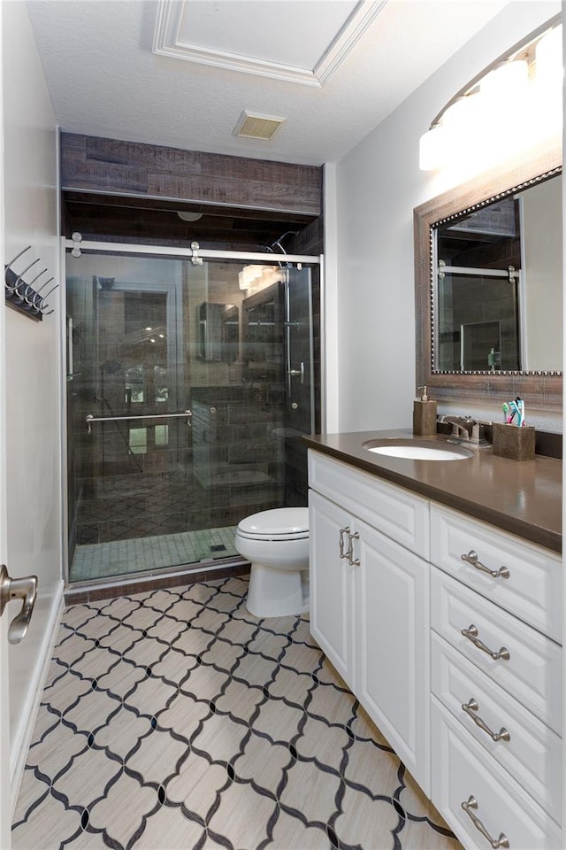 full bathroom featuring a stall shower, visible vents, toilet, and vanity