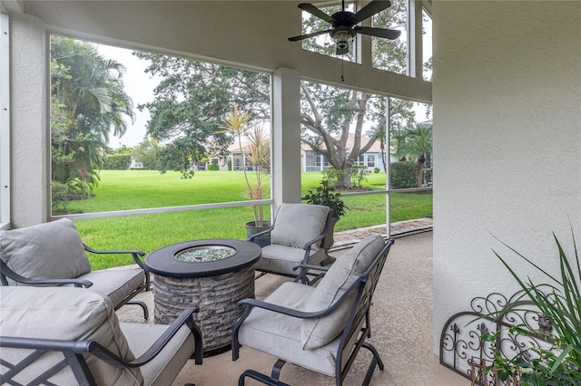 sunroom / solarium featuring a ceiling fan, an outdoor hangout area, and a healthy amount of sunlight