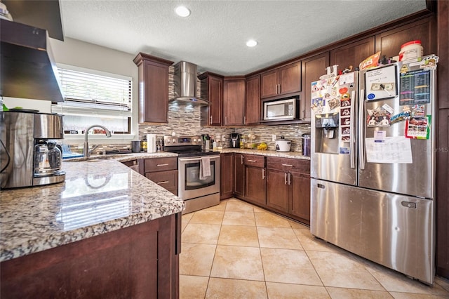 8135 Settlers Landing Trl N, Jacksonville, FL 32244 - kitchen featuring light tile patterned flooring, decorative backsplash, wall chimney exhaust hood, appliances with stainless steel finishes, and a sink