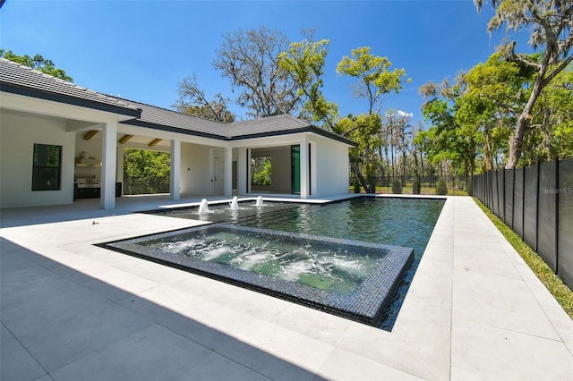 view of pool with fence, a fenced in pool, an in ground hot tub, and a patio area